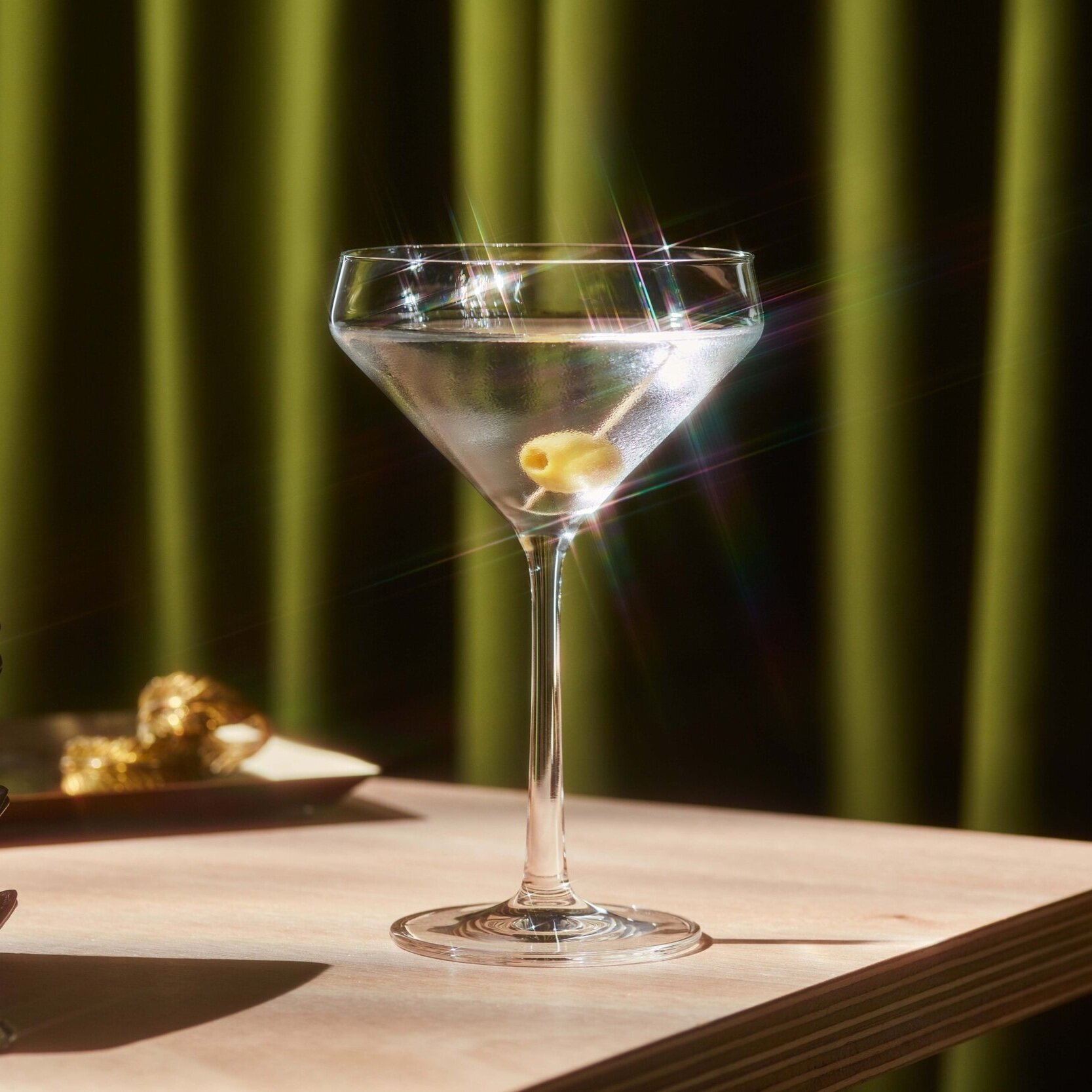 A martini cocktail with olives