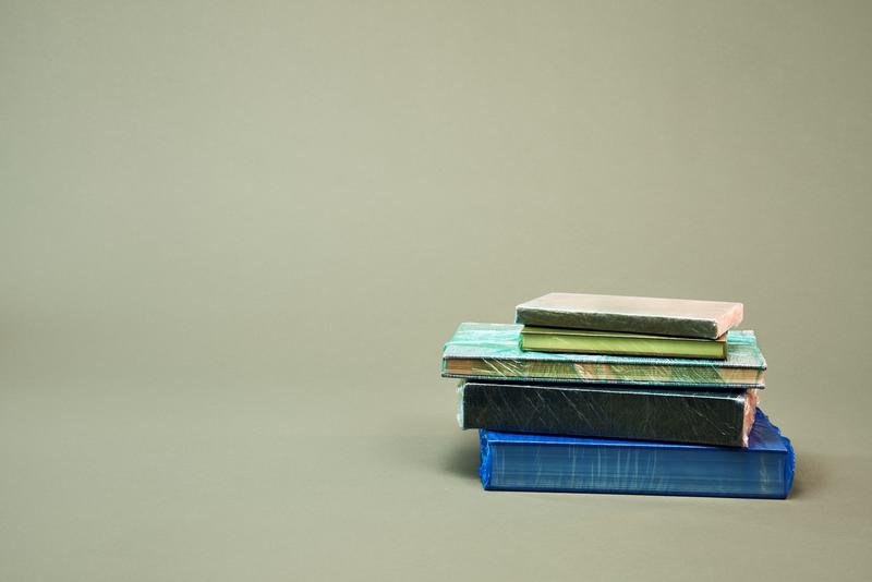 A stack of books on a light green backdrop