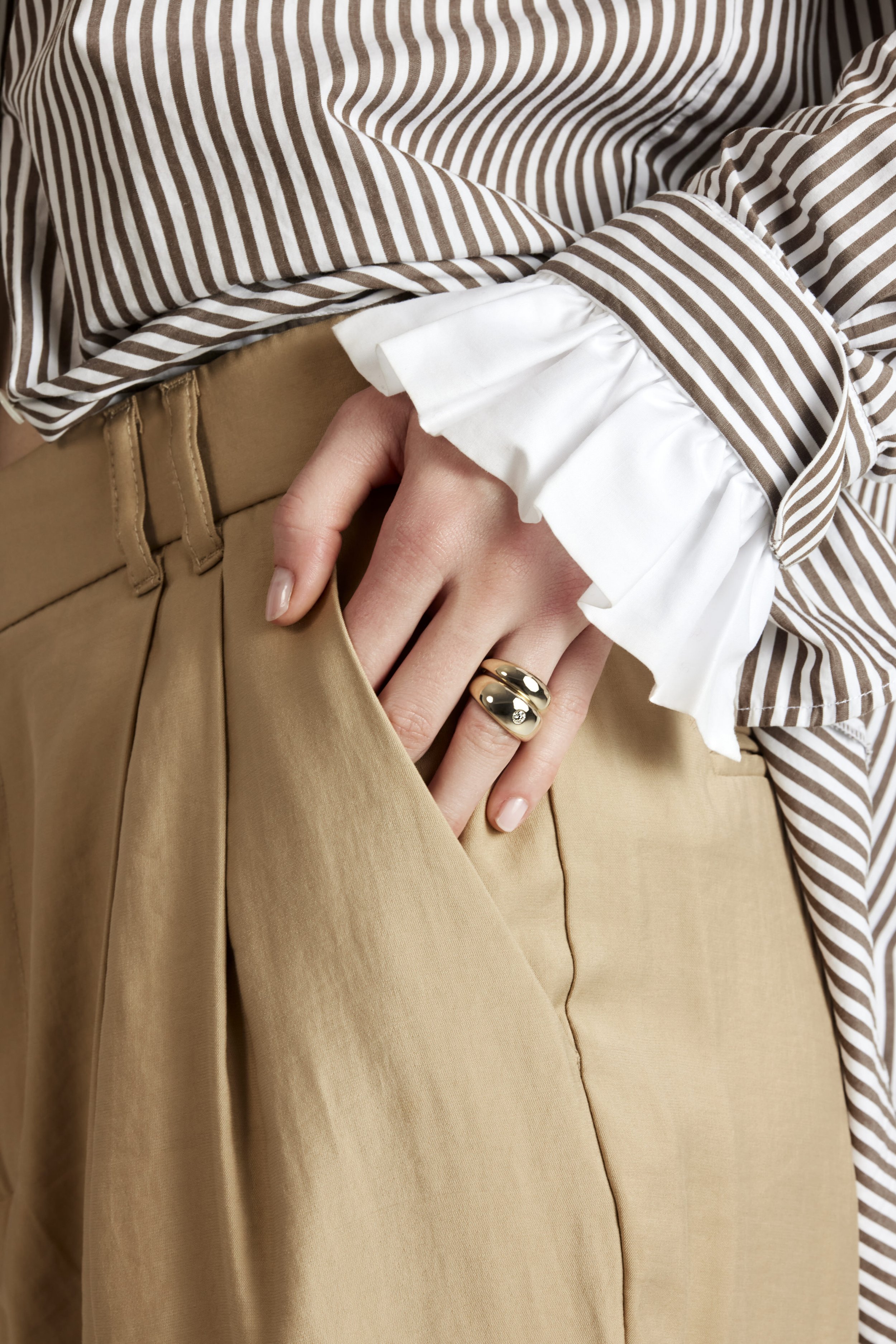 Jeweler setting diamonds into a gold ring on a workbench
