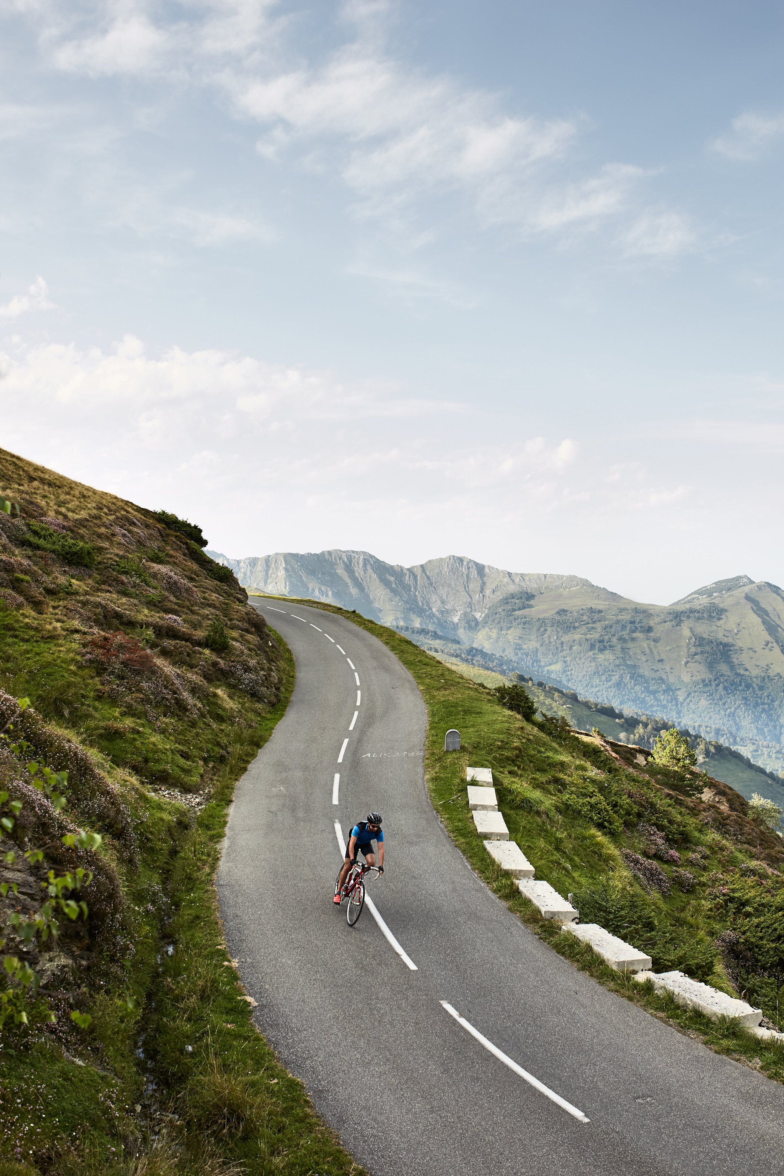 Male cyclist going downhill on a mountain road