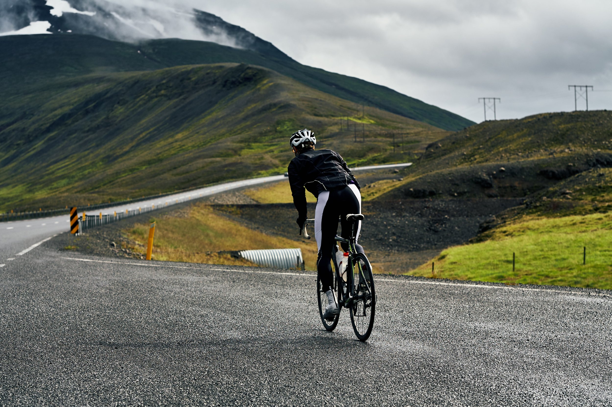 Road cyclist prepares to climb a mountain